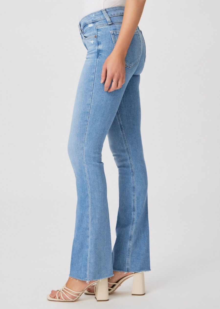 Paige Manhattan Boot 32" - Helena. A universally flattering mid-rise style with a fitted silhouette through the hips and thighs, a slim bootcut from the knee down and a slightly shorter 32” inseam. Cut from our TRANSCEND VINTAGE denim in a bright, powdery blue wash with lived-in details and a raw hem, this style has the look of authentic vintage denim but is incredibly comfortable with plenty of stretch and recovery.