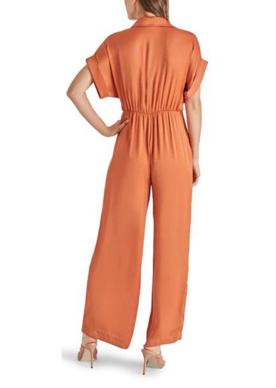 Steve Madden Tori Jumpsuit. Introducing the TORI jumpsuit. This washed satin jumpsuit features a tie front detail, wide-leg pants, and dolman sleeves. With a button front, collar neckline, and rolled sleeves, this jumpsuit is perfect for any season. Elevate your style with this satin beauty.