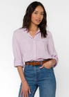 Velvet Heart Riley Shirt- Pastel Lilac. Our classic Riley silhouette, in soft and lightweight eco-friendly Tencel™ features a basic button-up collar, rounded high-low split hem, roll-tab sleeves, and chest pockets.
