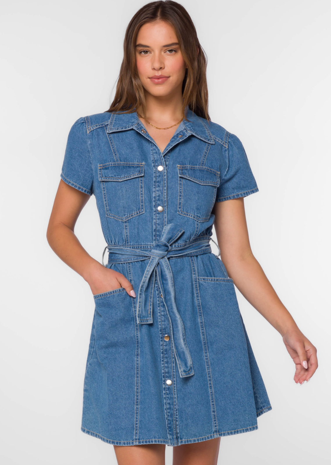 Velvet Heart Fonda- Western Blue. The Fonda Dress in<span> </span><span>Western Blue denim has short cap sleeves and metal snaps button-up with a self belt to cinch the waist for a flattering silhouette. Plenty of pockets and contrasting top-stitching completes the look.