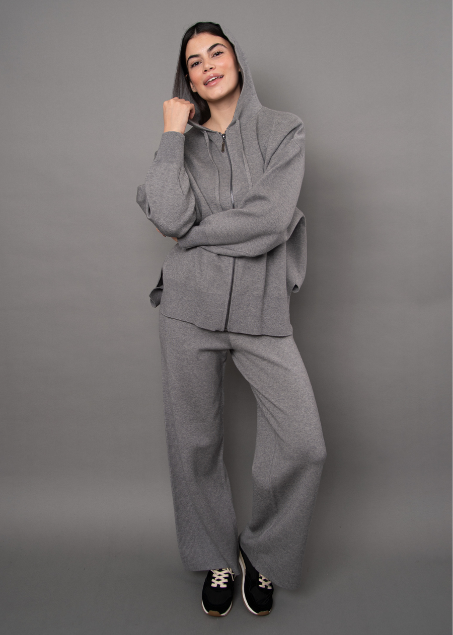 Elevate your off-duty wardrobe with this effortlessly chic and ultra-cozy grey melange knit sweater set. Designed for the ultimate combination of style and comfort, the relaxed-fit zip-up hoodie features an attached hood with adjustable drawstrings, drop shoulders, and a sleek full front zipper, while the matching wide-leg trousers offer an easy, flowing silhouette. Crafted from a soft, premium knit texture in a versatile heathered grey shade, this coordinated set is your go-to ensemble for luxurious loungi