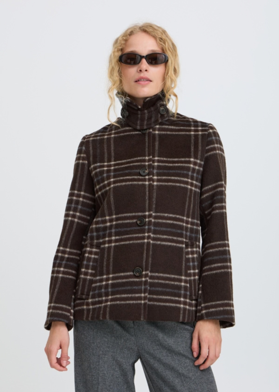 Wool look check jacket features a straight, slightly boxy silhouette with a pointed collar and button front. Hip-length design includes long sleeves and side pockets, offering a softly structured shape with a fuzzy texture throughout.