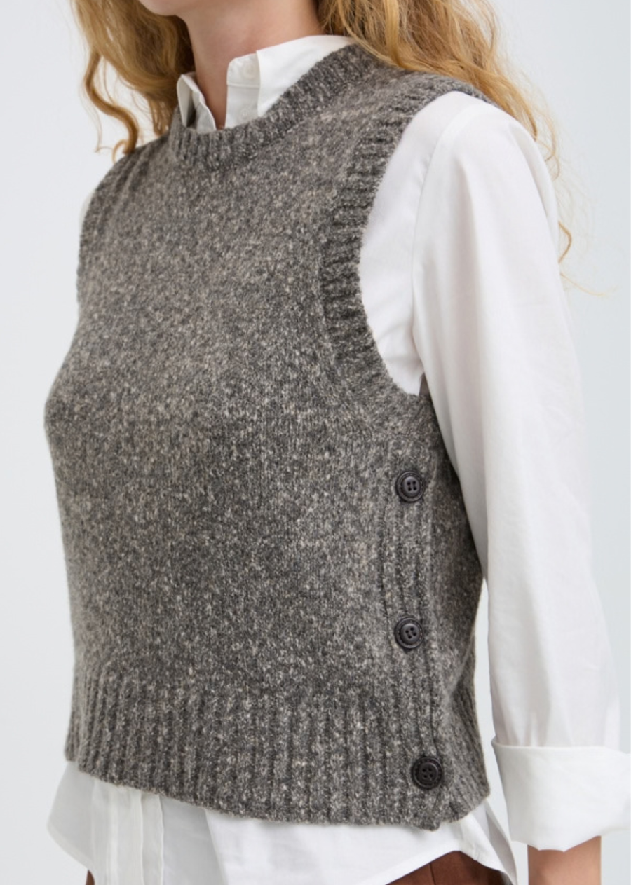 Add texture and effortless dimension to your wardrobe with this contemporary marled sweater vest. Designed with functional side-button detailing and a boxy, slightly cropped silhouette, it is the ultimate layering piece for autumn and winter styling.