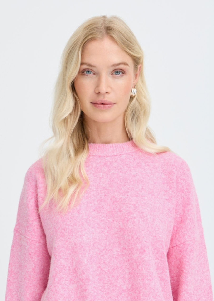 Bring a bright, playful pop of color to your cool-weather wardrobe with this cozy crew neck sweater in vibrant bubblegum pink. Crafted from a soft, fuzzy melange knit, this easy-going piece offers effortless comfort with a contemporary, chic finish. Classic ribbed crew neckline, dropped shoulder seams for a relaxed fit, and thick ribbed trimming at the cuffs and hem.