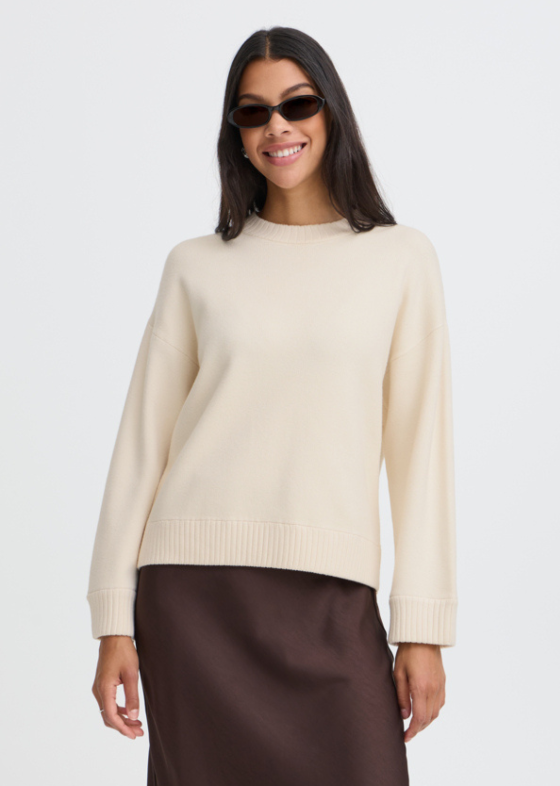 The ultimate cold-weather classic. Rendered in a soft cream shade, this relaxed crewneck sweater features dropped shoulders and wide ribbed trims at the collar, cuffs, and hem for a cozy yet polished finish. Cut with a modern, effortless drape, it’s a foundational piece designed to layer seamlessly over everything from tailored trousers to silky midi skirts.