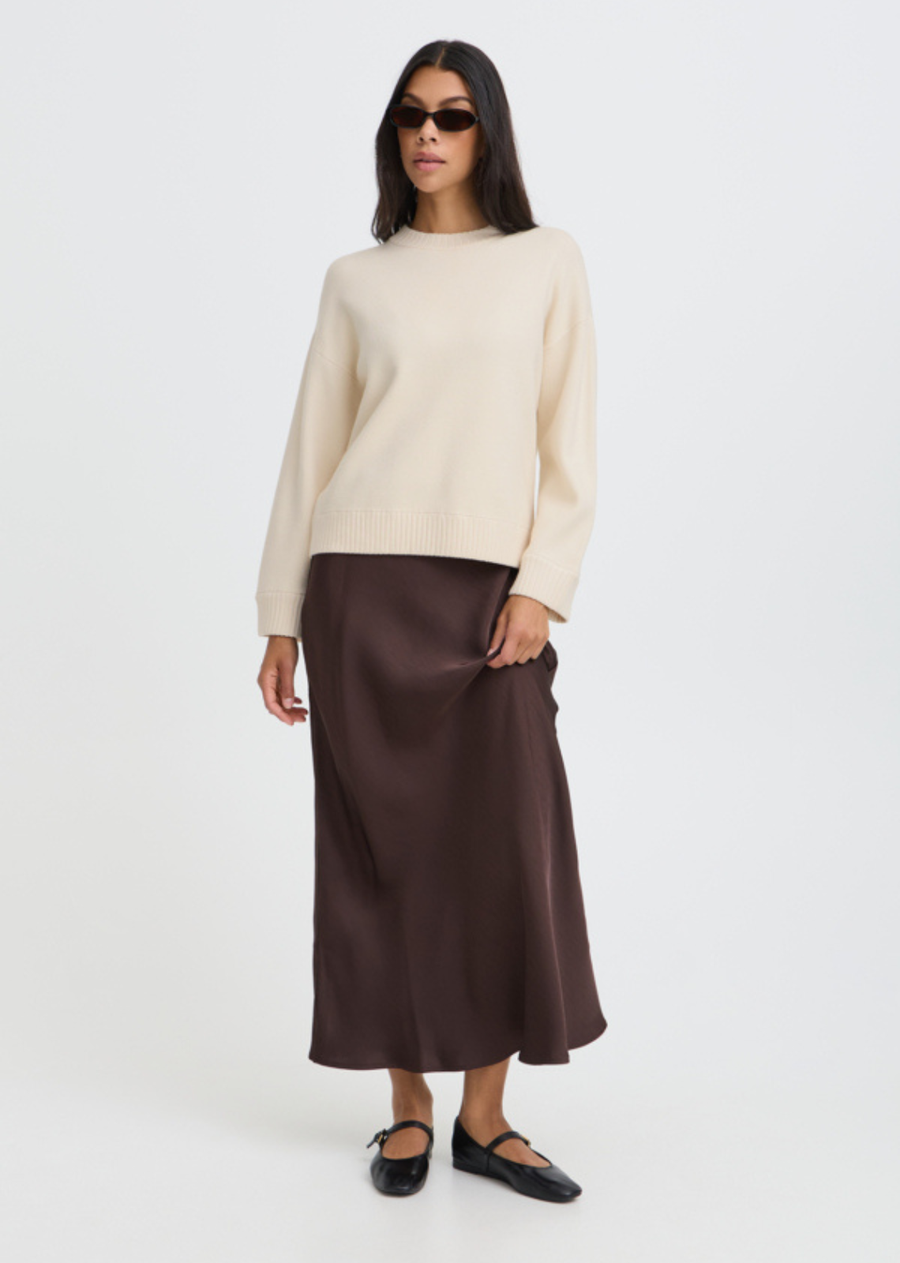 The ultimate cold-weather classic. Rendered in a soft cream shade, this relaxed crewneck sweater features dropped shoulders and wide ribbed trims at the collar, cuffs, and hem for a cozy yet polished finish. Cut with a modern, effortless drape, it’s a foundational piece designed to layer seamlessly over everything from tailored trousers to silky midi skirts.