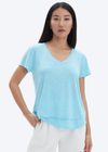CHRLDR Ava V-Neck T-Shirt- Vivid Cyan. 50% Pima Cotton 50% Modal - Slub Jersey Smooth buttery feel Mock layer details at hem Care: Machine wash cold Made in Peru Model is 5’9” wearing a size S