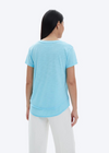 CHRLDR Ava V-Neck T-Shirt- Vivid Cyan. 50% Pima Cotton 50% Modal - Slub Jersey Smooth buttery feel Mock layer details at hem Care: Machine wash cold Made in Peru Model is 5’9” wearing a size S