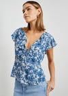 Rails Carmine Top. Dreaming of warm summer days ahead, this lovely Carmine Top Chambray Floral&nbsp;from&nbsp;Rails&nbsp;would be the perfect fit. A stunning blue floral design with a ruffled collar and a tie detail at the bust. This lightweight top is cut with cap sleeves ensuring you keep nice and cool whilst looking super cute! Style with a pair of white jeans for a crisp look or a little skirt which would be the perfect summer look.