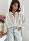 Charli Maya Blouse-White. Romantic soft cotton voile blouse with mandarin collar is an easy way to elevate your off duty look. Relaxed fit with balloon sleeves makes a great styling foundation piece that can be teamed with denim or higher waisted trousers. Pearl buttons give a luxe feel to a versatile wardrobe classic.
