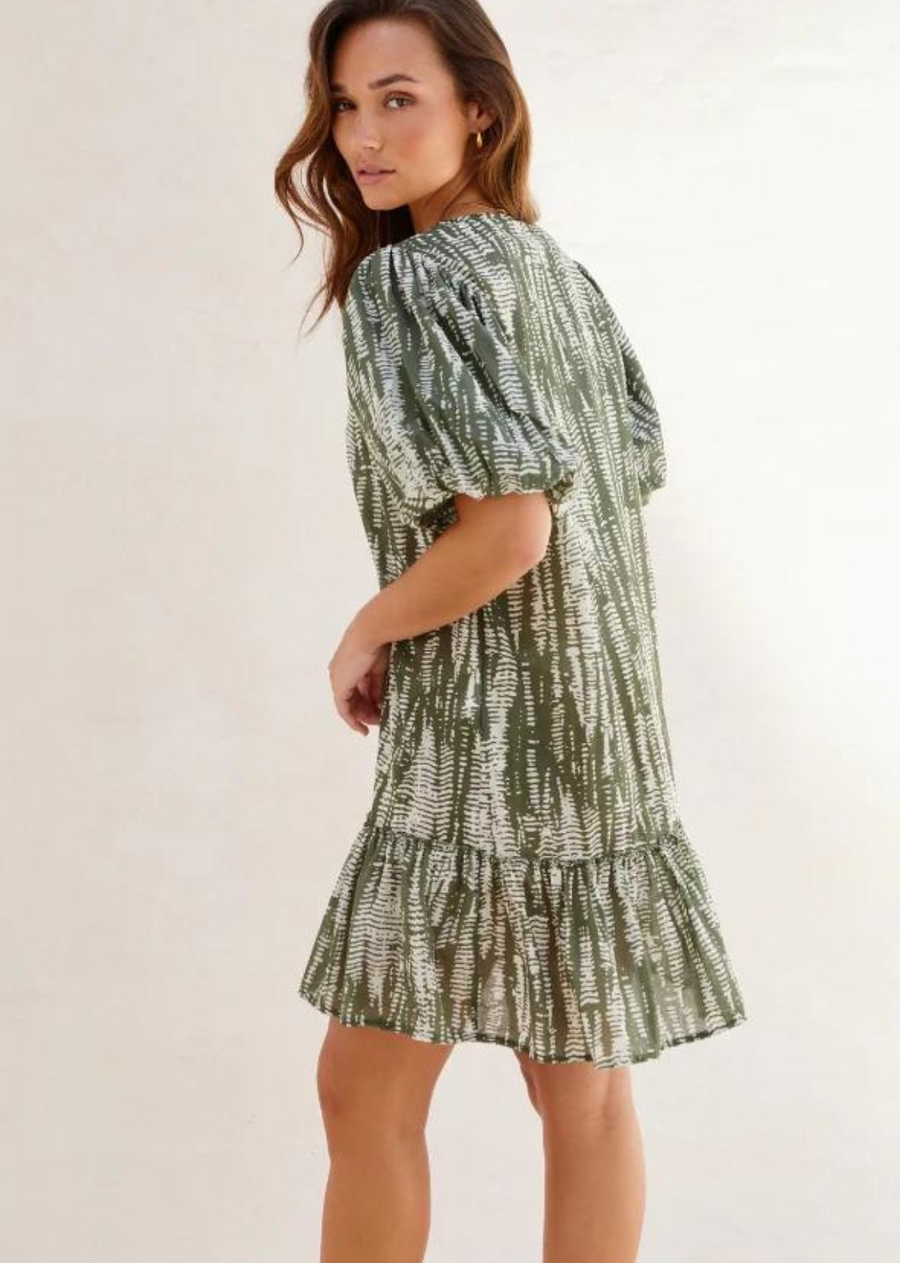 Charli Tia Dress. Tia is a v-neck dress in an shibori inspired print. Feminine smocking detail and an easy-fit option when you need a floaty throw on dress. Slight puff sleeve with elegant v-neckline. The perfect beach cover up or wear on warm days for adventures closer to home.