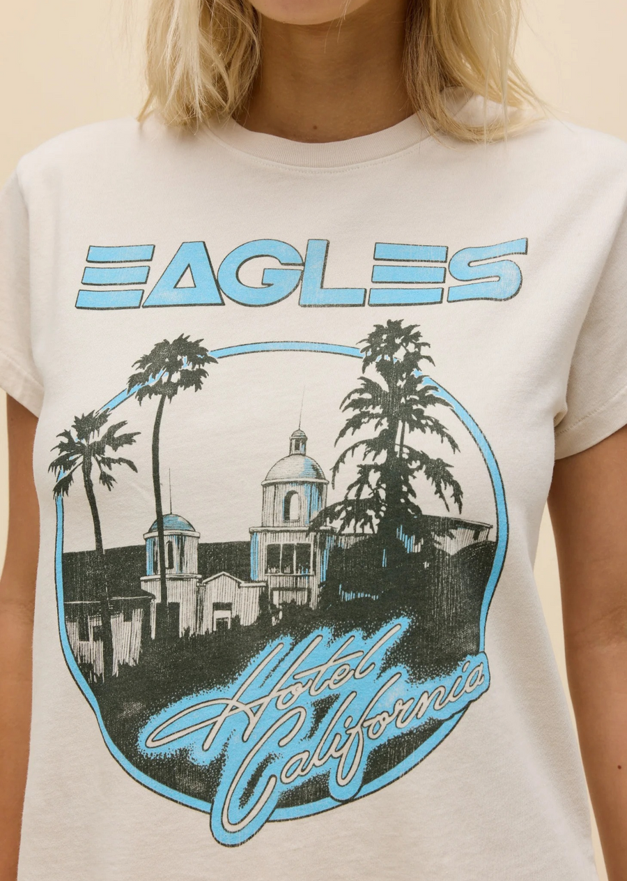 The legendary rock band has officially joined our roster. Record-breaking releases and harmonies hard to hit cemented the Eagles as major icons of the 70s. Celebrate their cultural touchstones in this Tour Tee featuring their top track and award winning, namesake album, Hotel California.