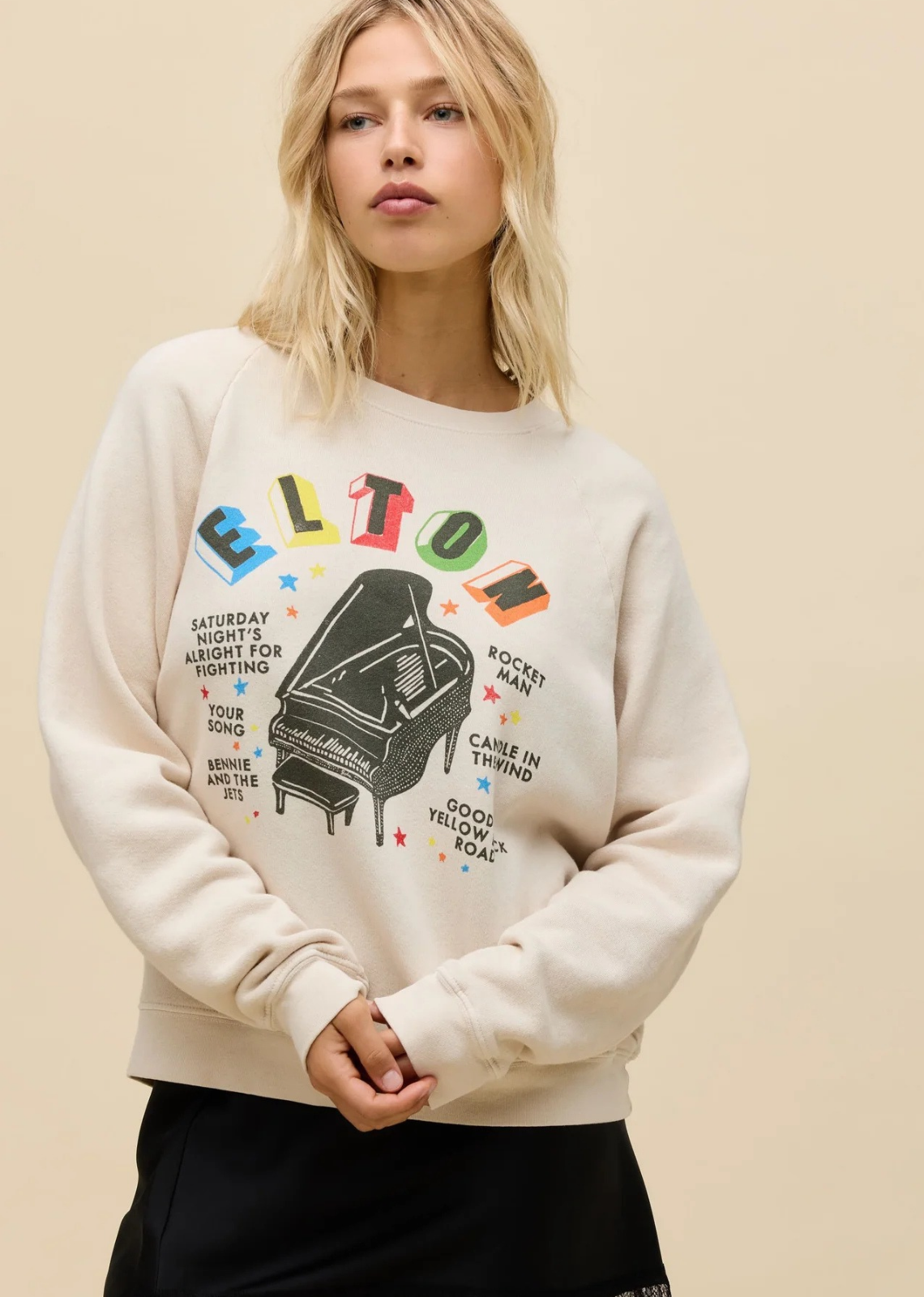 Fit to represent the piano prodigy himself, this multi-colored Elton John Vintage Raglan Sweatshirt highlights the resounding name that's synonymous with stylistic showmanship and a contagious personality. The legend's most iconic, everlasting songs anchor a piano graphic.