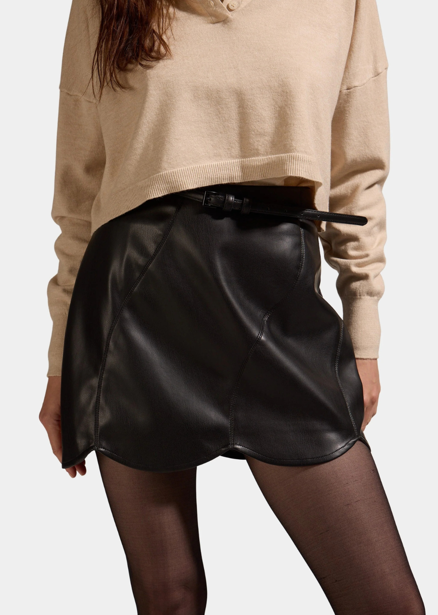 Edgy sophistication meets feminine tailoring in this sleek black faux leather mini skirt, featuring architectural paneling and a eye-catching curved hemline.