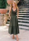 Elan Maxi Tank Dress. The maxi tank dress with mixed media, features different materials for the top and bottom. With a tiered skirt and pockets, and a fitted knit V-neck tank top, it's is a stylish and comfortable choice for various occasions!