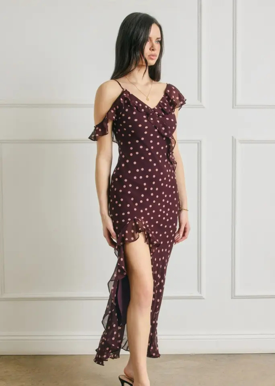 This elegant polka dot maxi dress features a cascading asymmetrical ruffle details for a feminine, flowing silhouette. The wide V-neckline and open back add an alluring touch, while adjustable shoulder straps allow for a comfortable, customizable fit. Finished with an open hem and soft lining, this dress is perfect for special occasions, romantic evenings, and elevated events.