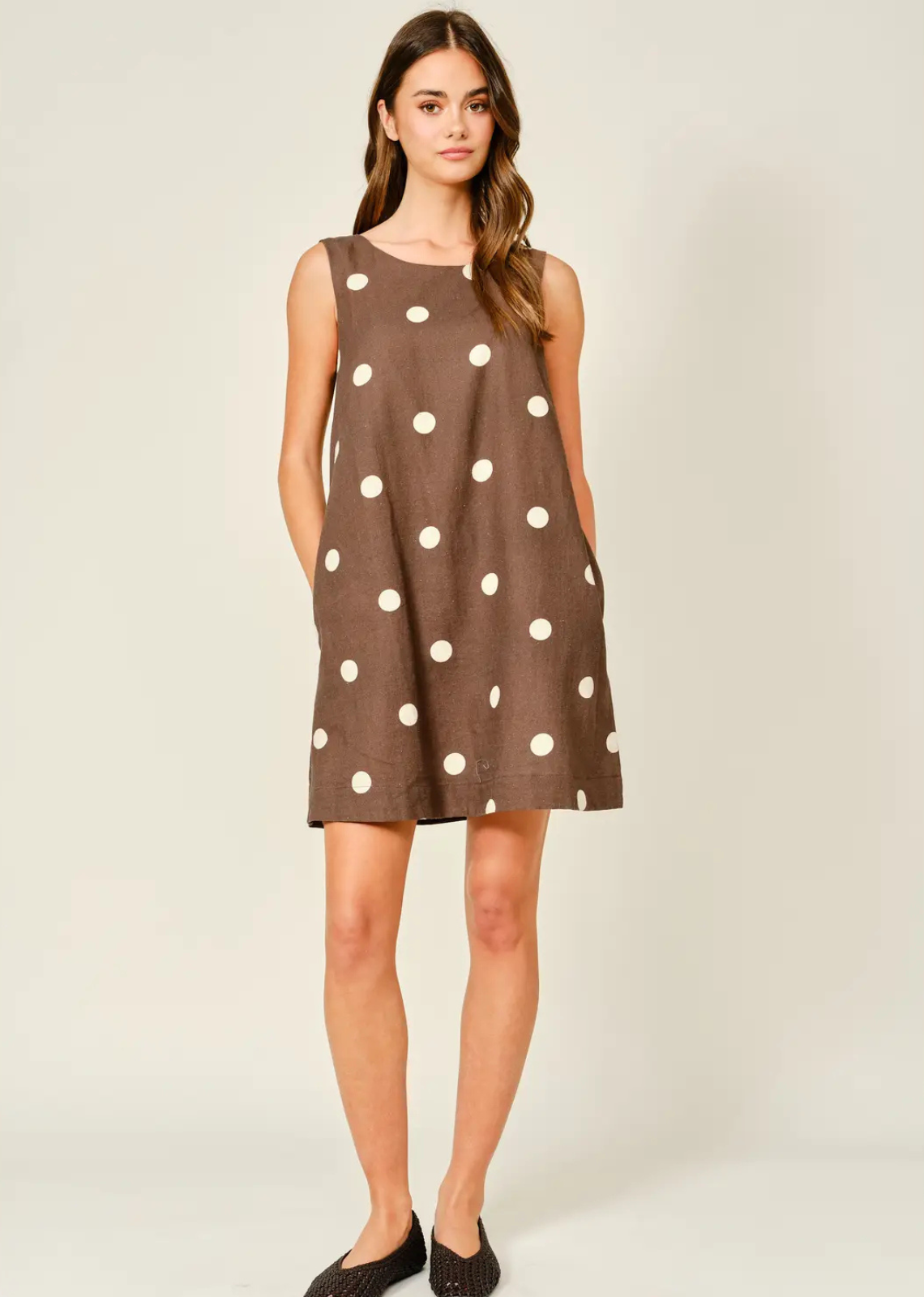 Soft, airy, and effortlessly chic, this linen-blend mini dress features a classic polka dot print for a timeless look. The sleeveless design keeps you cool, while the relaxed fit and flirty mini length create a flattering, easy silhouette. Perfect for casual summer days or layered styling.