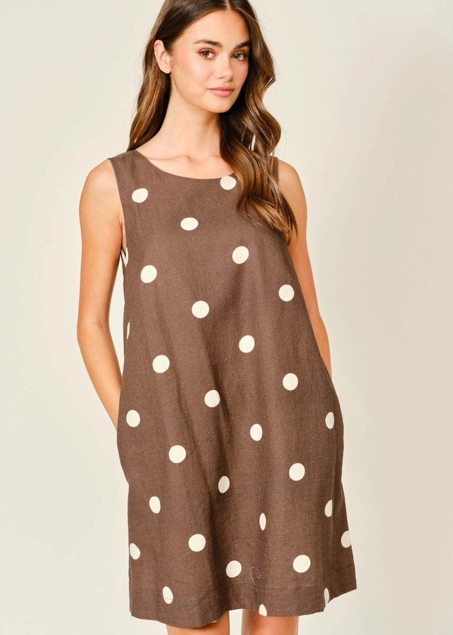 Soft, airy, and effortlessly chic, this linen-blend mini dress features a classic polka dot print for a timeless look. The sleeveless design keeps you cool, while the relaxed fit and flirty mini length create a flattering, easy silhouette. Perfect for casual summer days or layered styling.