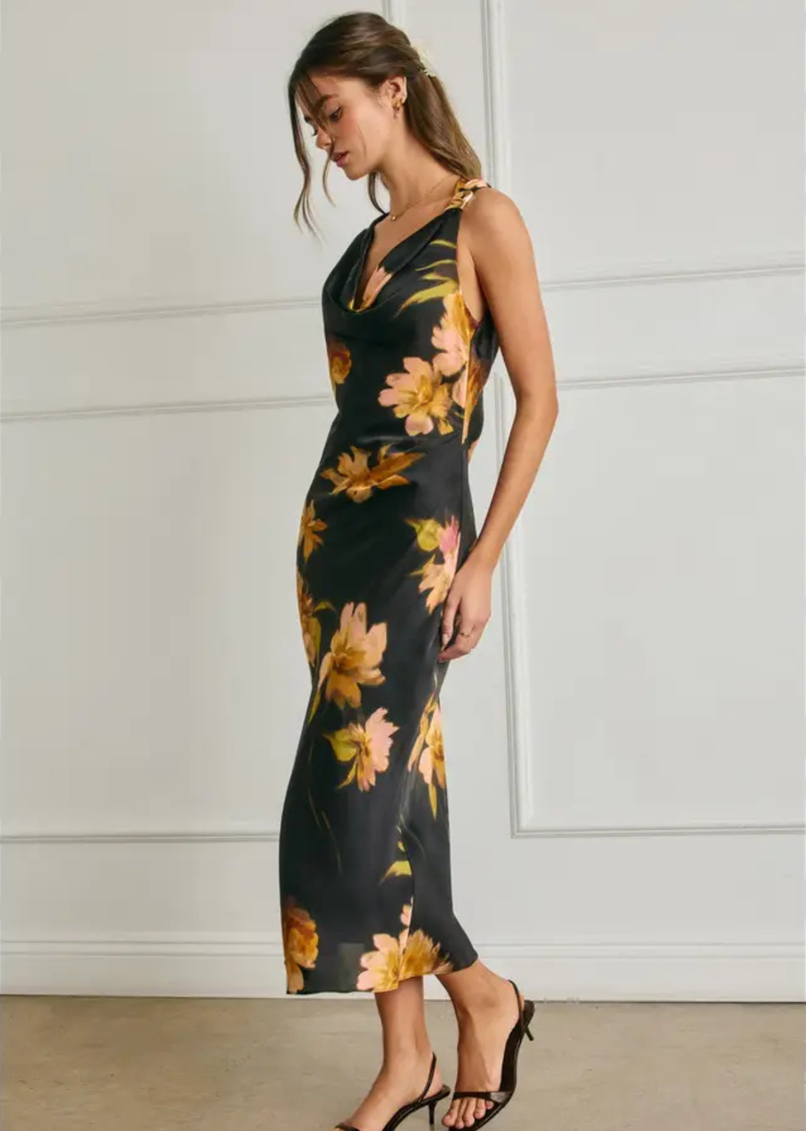 Elegant and effortlessly feminine, this floral satin midi dress features a soft, fluid silhouette with a beautiful drape. A delicate cowl neckline is complemented by a statement metal shoulder trim, while subtle pleating at the left waist creates a flattering, sculpted shape. Finished with a sleek midi length and smooth satin finish, it’s an elevated choice for special occasions and evening events.