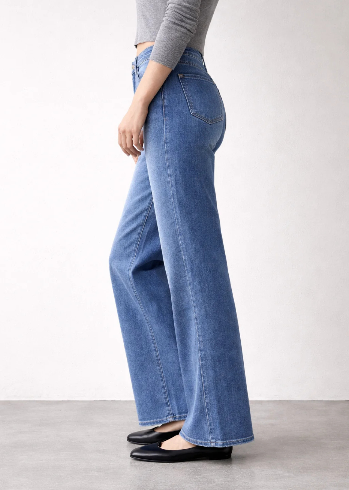High-rise wide-leg jeans in a soft faded blue wash with a relaxed draped fit and 20-inch leg opening.