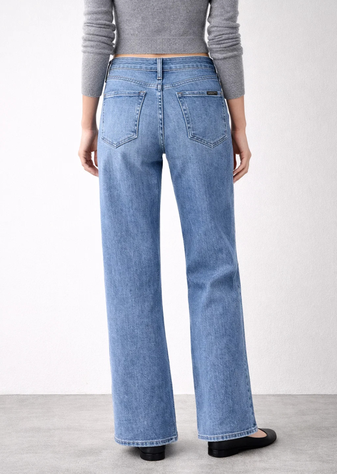 High-rise wide-leg jeans in a soft faded blue wash with a relaxed draped fit and 20-inch leg opening.