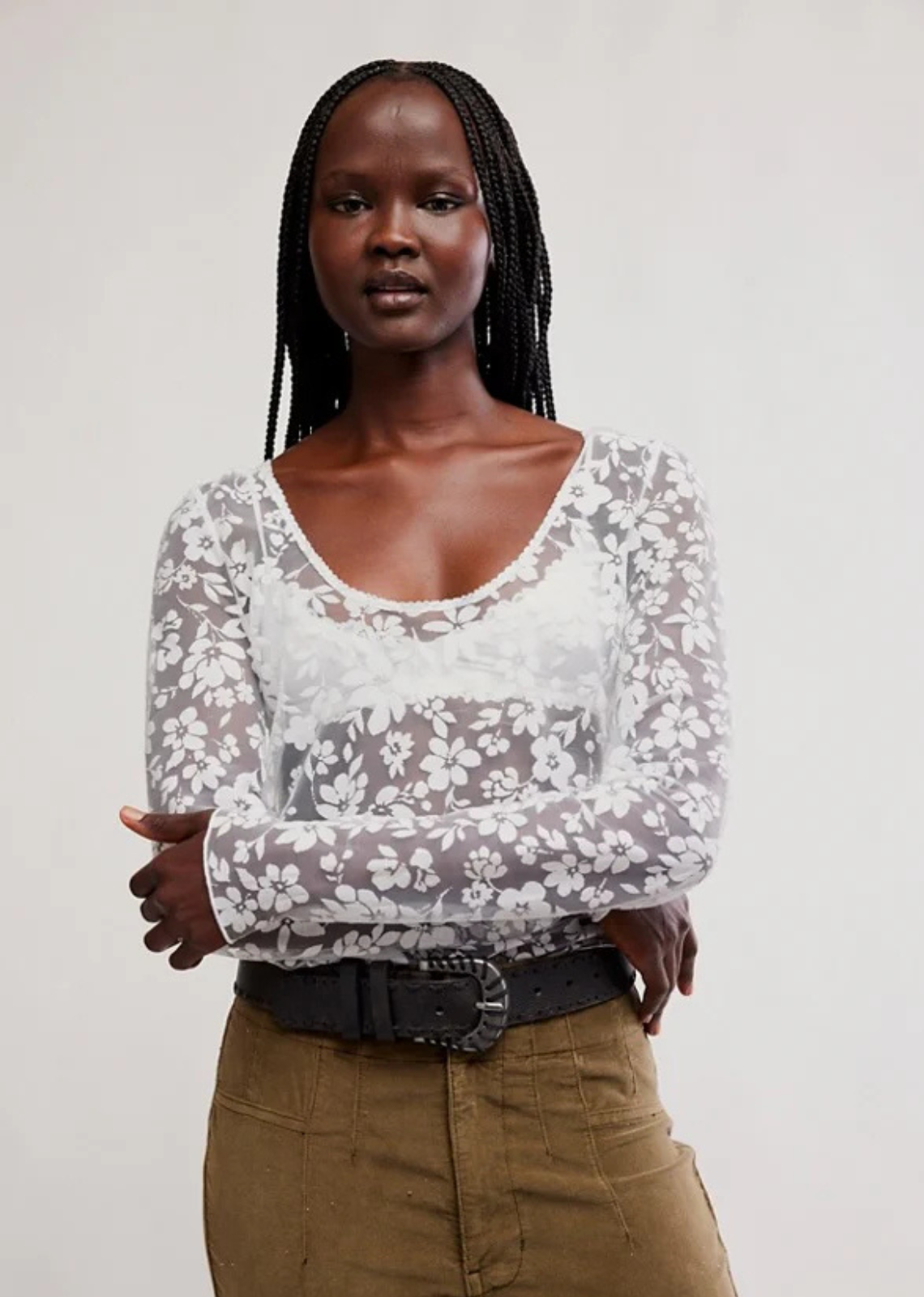 Romantic with a modern edge, this black lace top brings effortless elegance to any look. Designed with intricate floral lace and a semi-sheer finish, it offers a feminine silhouette that's perfect for layering or wearing on its own. Round neck, long sleeve