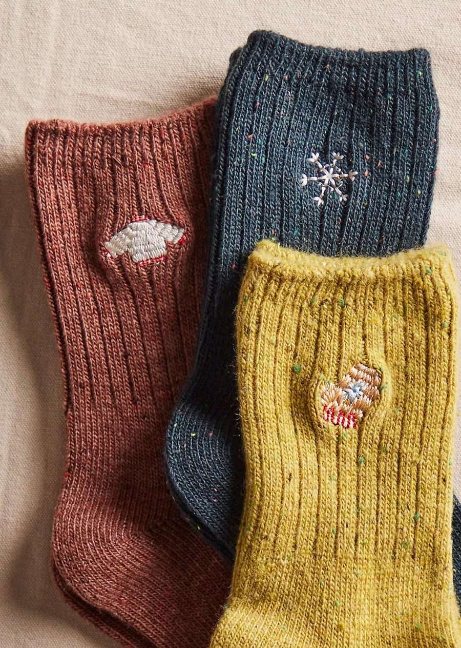 Great for gifting or gracing your own accessories collection, this forever classic sock pack features three pairs of crew style socks designed in a speckled, ribbed knit fabrication with seasonal embroidery at top for the perfect special finish.
