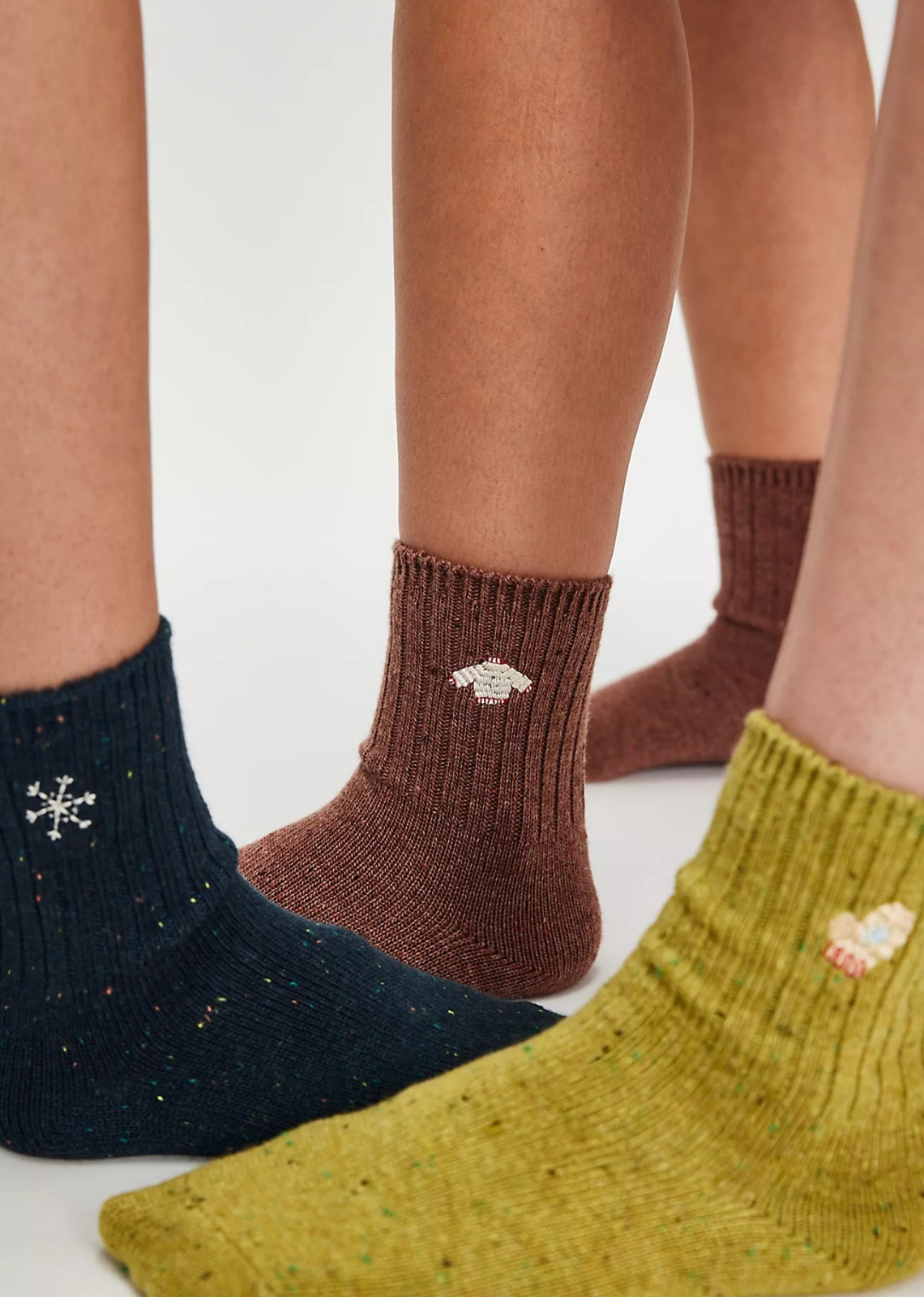 Great for gifting or gracing your own accessories collection, this forever classic sock pack features three pairs of crew style socks designed in a speckled, ribbed knit fabrication with seasonal embroidery at top for the perfect special finish.
