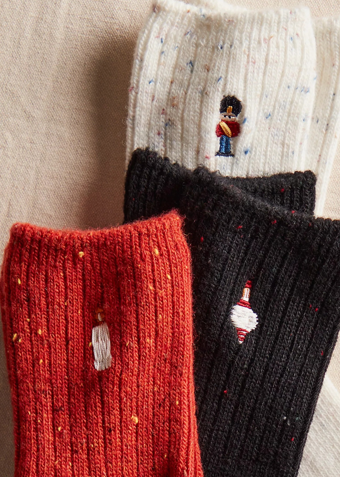Great for gifting or gracing your own accessories collection, this forever classic sock pack features three pairs of crew style socks designed in a speckled, ribbed knit fabrication with seasonal embroidery at top for the perfect special finish.