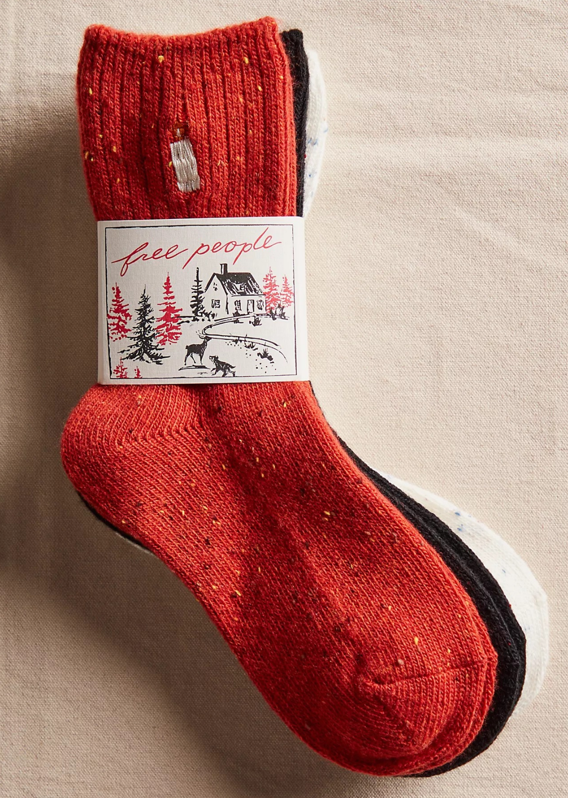 Great for gifting or gracing your own accessories collection, this forever classic sock pack features three pairs of crew style socks designed in a speckled, ribbed knit fabrication with seasonal embroidery at top for the perfect special finish.