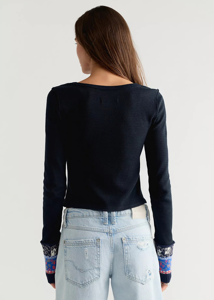 A quintessentially FP look, this charming cardi from the We The Free&nbsp;collection features a flattering, fitted silhouette, a ribbed cotton fabrication, and bold embroidered paneling and cuffs for an added touch.