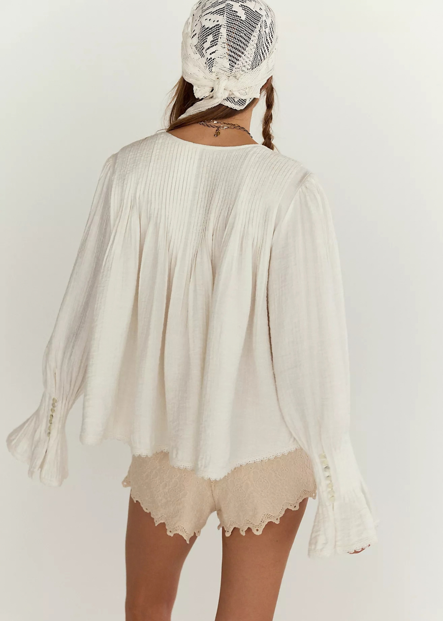 Elevate your ensemble with a touch of charm: this breezy top features a flowy blouse silhouette, all-over pintucks, and a lightweight, breezy fabrication for an airy hand feel.&nbsp;