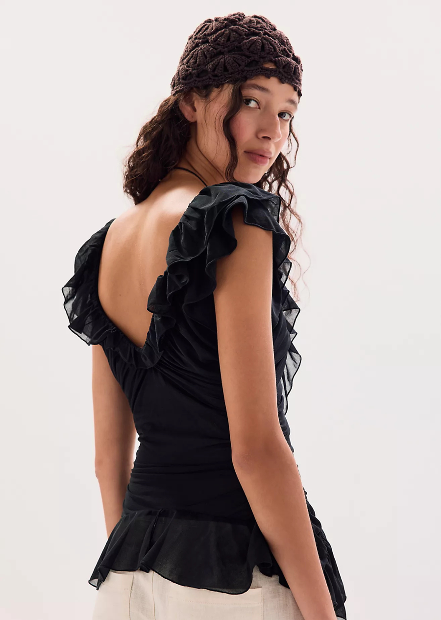 It doesn’t get more playful than this eye-catching top, featuring a fitted, longline silhouette, stretchy ruched fabrication, and a cascading ruffle design for added detail.