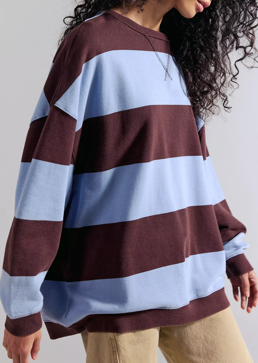 So cool and classic, this timeless crewneck is featured in an oversized, slouchy silhouette and staple striped print with contrasting hems for added dimension.