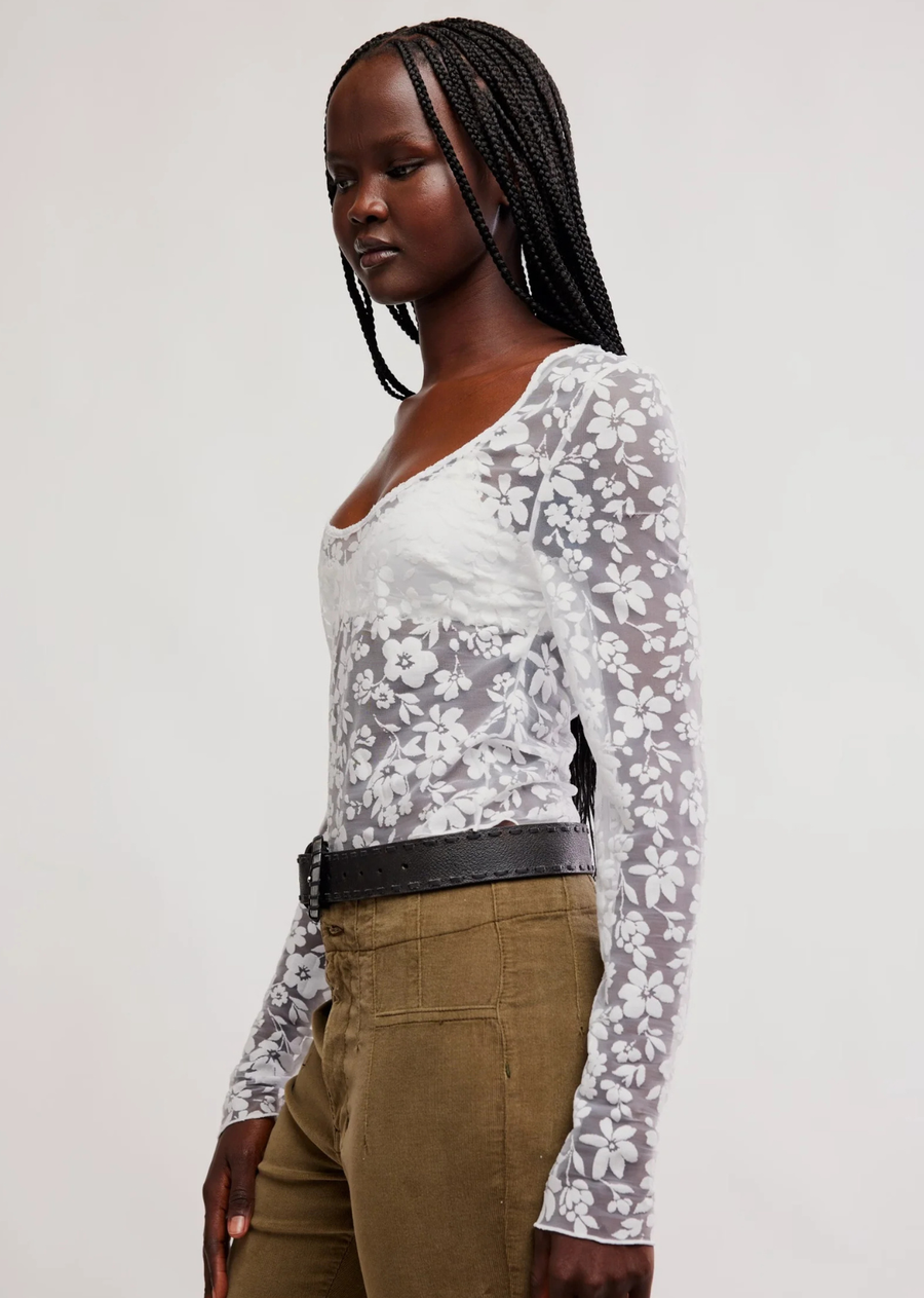 Romantic with a modern edge, this black lace top brings effortless elegance to any look. Designed with intricate floral lace and a semi-sheer finish, it offers a feminine silhouette that's perfect for layering or wearing on its own. Round neck, long sleeve