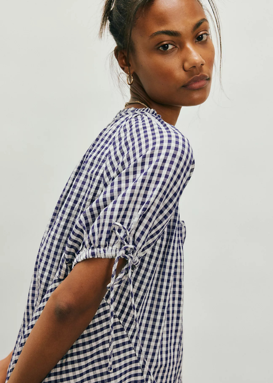 Add instant charm to any look with this sweet tunic top, featuring a floaty silhouette and puffed sleeves, finished with a button closure for endless ways to wear.