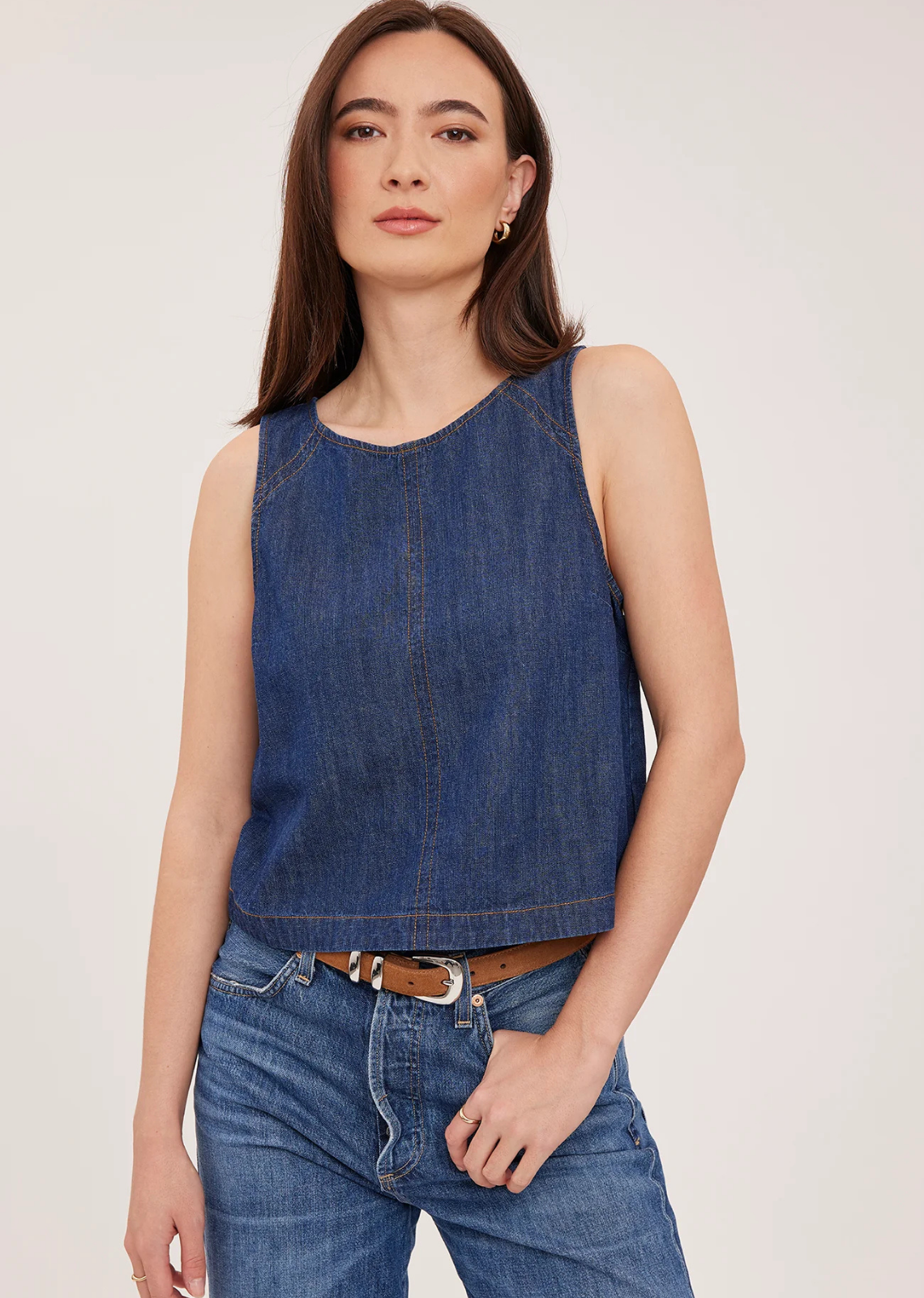 The Blaise tank is made of a denim fabric that has been specially washed for a perfectly lived-in look. Features include contrast topstitching details and back keyhole closure.