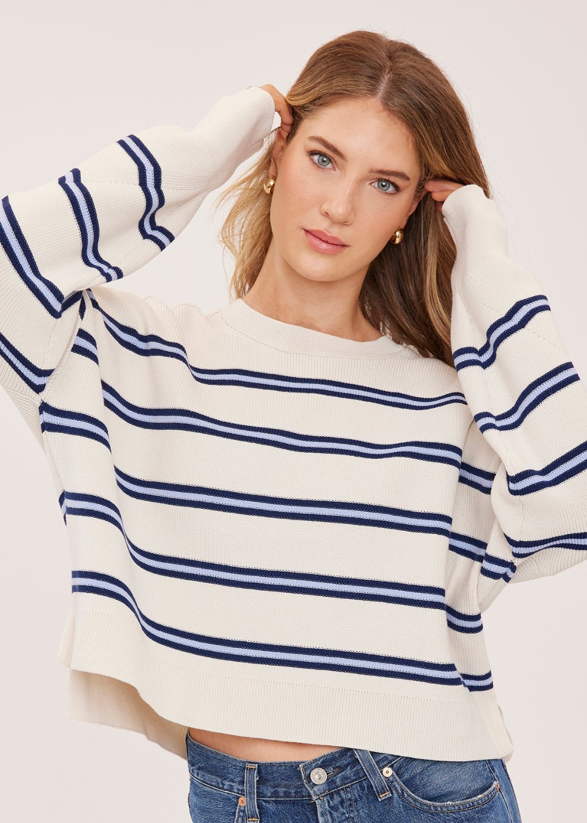 The Echo sweater is made of a super soft yarn in a half cardigan stitch. Features include exposed seam detailing and side slits for an effortless look.