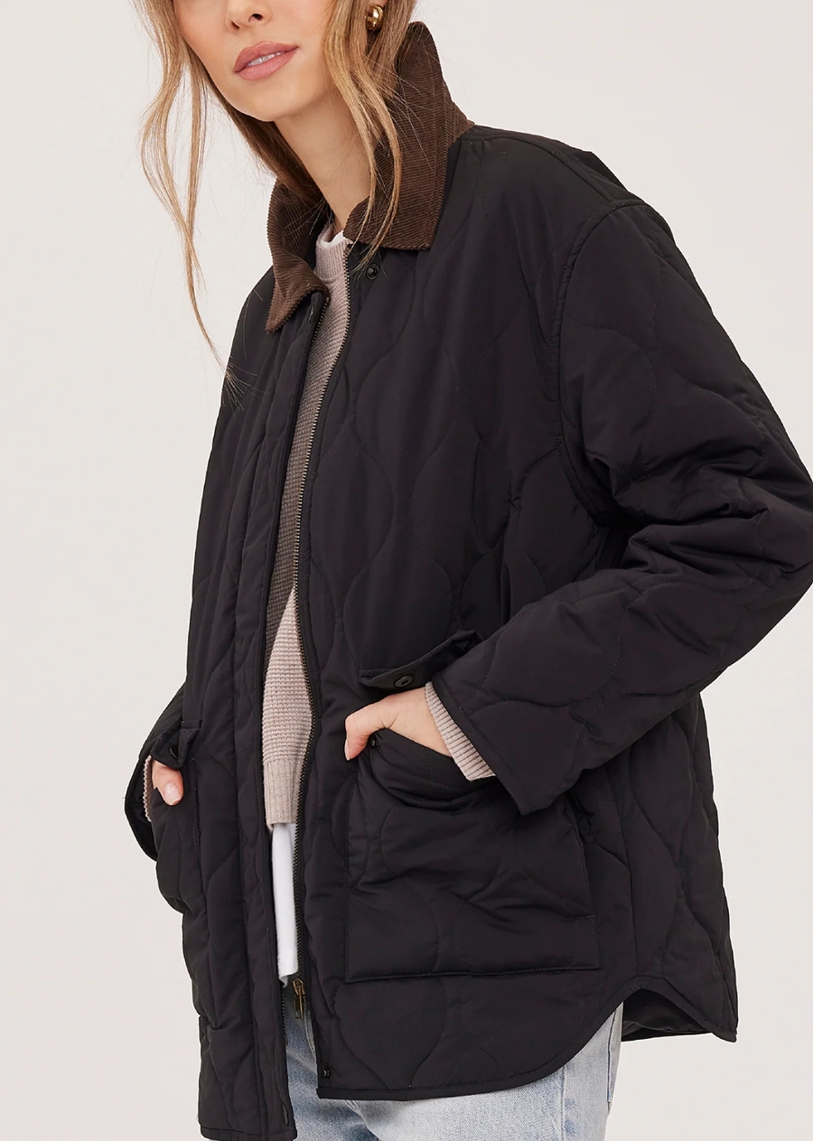 The Felix jacket is made of brushed nylon fabric with a quilted pattern throughout. Features include a contrast corduroy collar and dual-entry pockets.