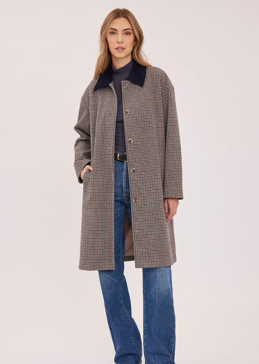 The Millie coat is made of a brushed herringbone fabric and is fully lined. Features include a contrast corduroy collar, welt pockets, and a back vent.