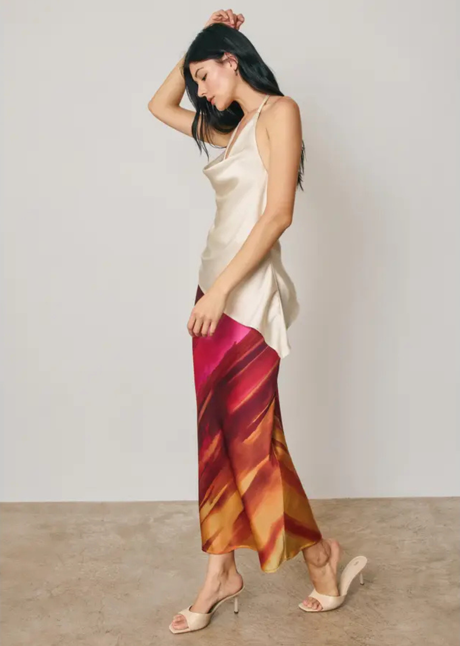 The Golden Hour Maxi Skirt features a dreamy watercolor-inspired stripe print in a smooth satin finish. Designed with a flattering A-line silhouette, this effortless maxi skirt drapes beautifully while offering comfortable wear with its hidden elastic waistband and easy pull-on design. A versatile statement piece perfect for sunny days, vacations, and elevated everyday styling.