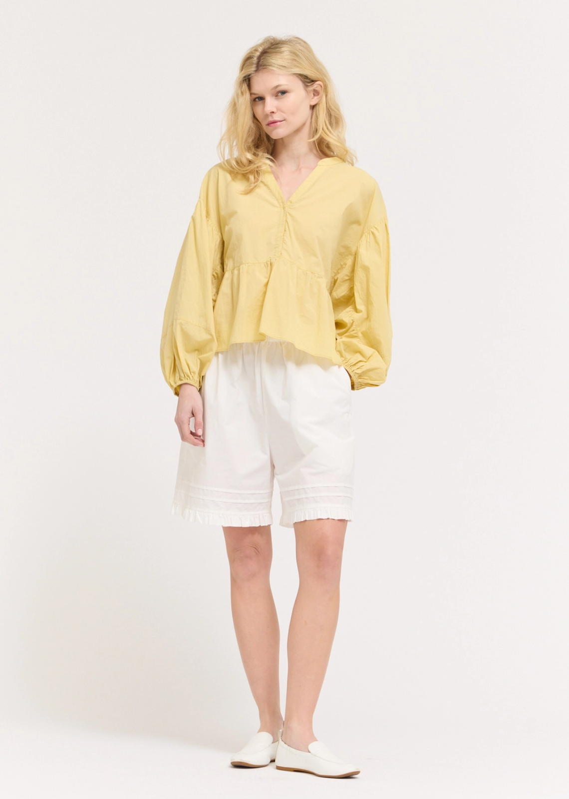 Romantic and effortlessly refined, this panel balloon sleeve blouse brings elevated style to any wardrobe. Designed with softly structured panel detailing and voluminous balloon sleeves, it creates a flattering silhouette with beautiful movement