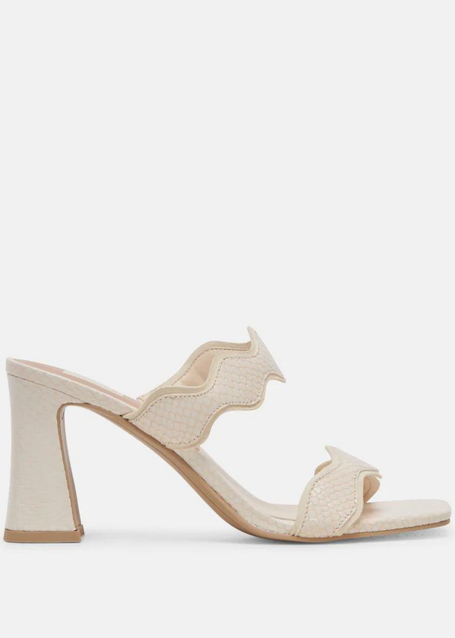 Dolce Vita Ilvia Heels- Creme Embossed Leather. ILVA is the center of attention. A sculptural heel and scalloped straps make this the perfect party style. Choose from sophisticated suede hues or opt for statement-making leather.