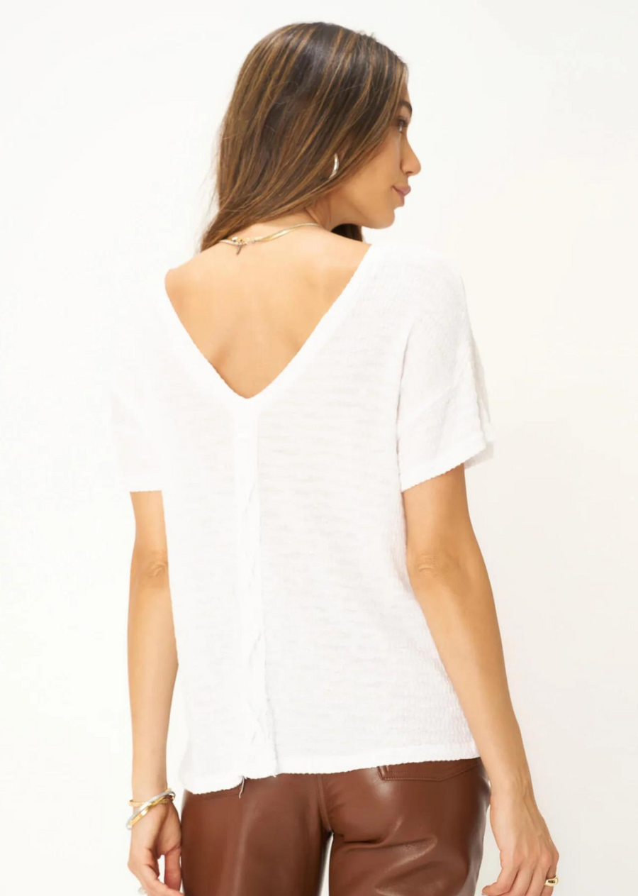 Project Social T Isadora Back Lace Up Tee. The Isadora Back Lace Up Striped Rib Easy Fit Tee features a relaxed fit, tonal striped rib fabric, scoop front neckline, and drop shoulders, creating an effortlessly comfortable style. The plunge back silhouette paired with the center lace-up detail will make this tee stand out all summer long.
