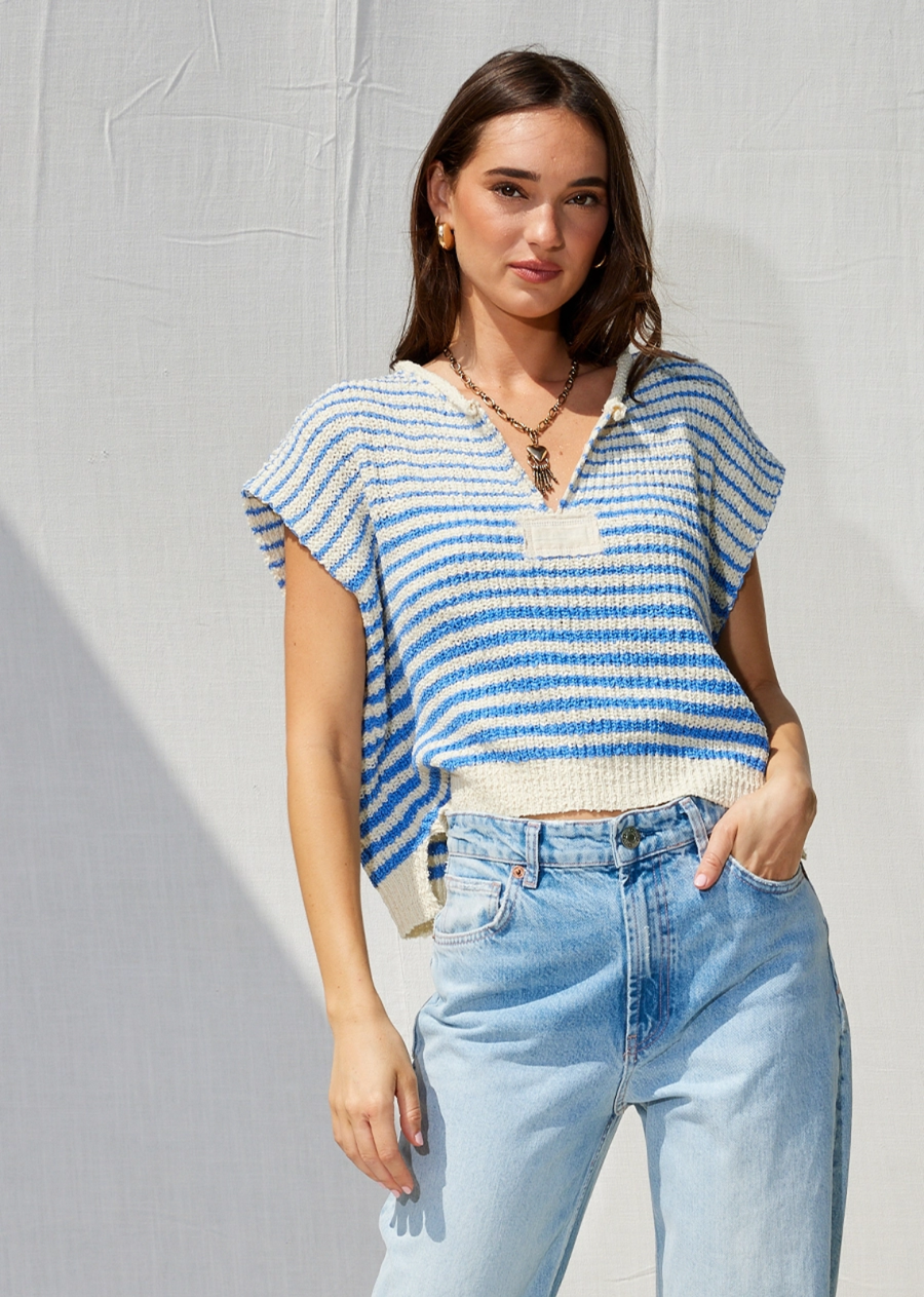 A best-selling and trending favorite, this slouchy cropped top features a loose fit, striped design, V-neckline, cap sleeves, and bold solid patches at the front and back.