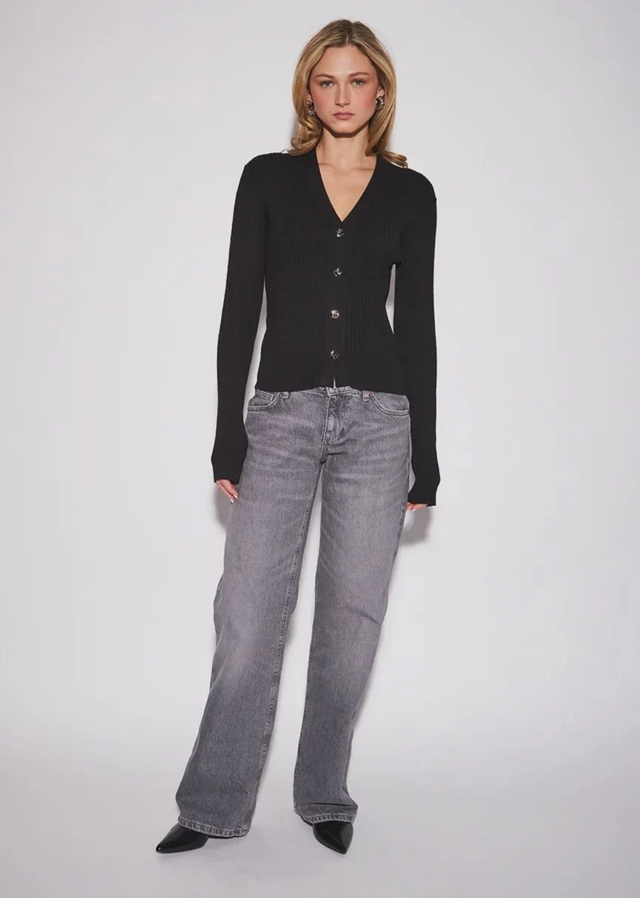 Effortlessly chic and endlessly versatile, the John &amp; Jenn Maura Cardigan is a timeless wardrobe essential! Featuring a flattering V-neckline, delicate button-front closure, and a relaxed silhouette, this soft knit brings a polished, feminine touch to everyday dressing. Wear it buttoned up with your favourite denim for a classic look, or layer it over a simple tank with tailored trousers for effortless sophistication.