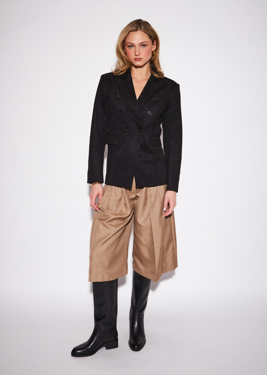 The Orson Blazer is crafted in a rich black faux suede, bringing sophistication and versatility to your wardrobe. Perfectly polished for the office yet effortlessly chic for a night out.