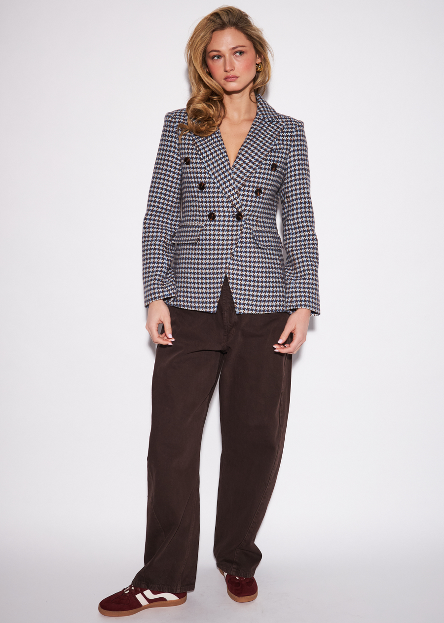 The Jodi brings a distinctly tailored, menswear-inspired attitude to the knitwear collection. Designed with a classic blazer&nbsp;silhouette, its all-over check pattern adds structure and visual depth while maintaining a polished, versatile feel. Wear it with&nbsp;relaxed denim and boots for an elevated take on casual dressing, or pair it with coordinating trousers for a sophisticated suiting&nbsp;moment. A strong layering piece that adds instant structure to the wardrobe.
