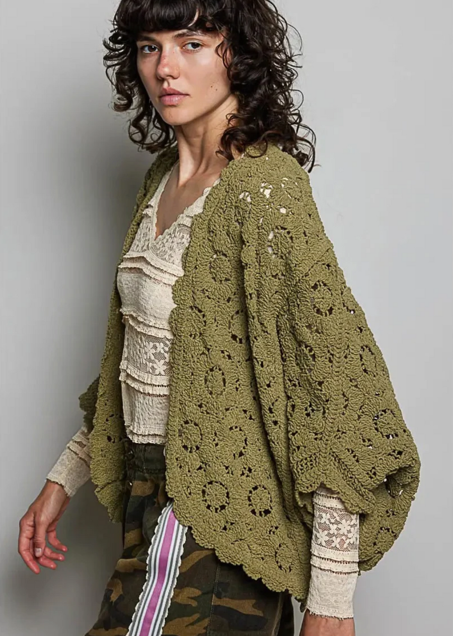 The Journi Cardigan in black is a romantic crochet layer featuring an open-front design, scalloped edges, and delicate floral detailing. Its relaxed fit and airy texture make it an easy statement piece to throw over tanks, tees, or dresses.