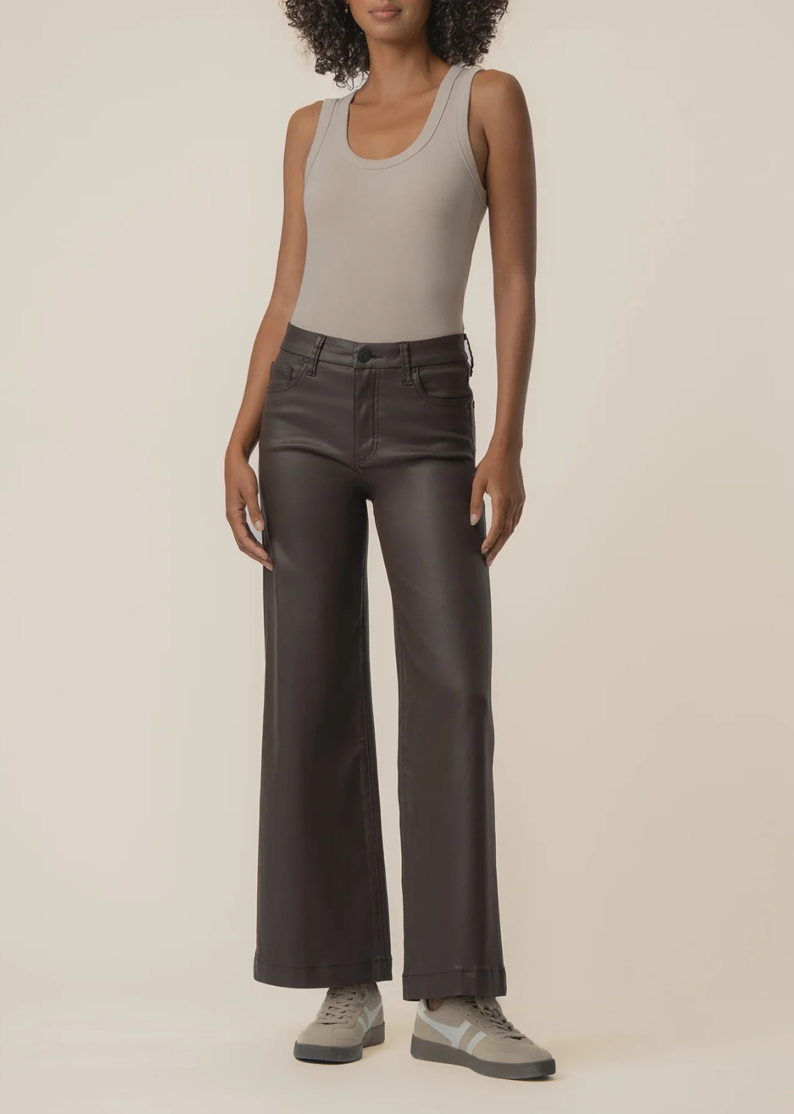The Meg High Rise Wide Leg from Kut From The Kloth is an elevated take on an everyday staple. Designed in a rich chocolate brown with a sleek coated finish, these jeans feature a flattering high-rise waist and relaxed wide-leg silhouette. The ankle-length cut makes them perfect for pairing with boots, heels, or sneakers for an effortlessly polished look.